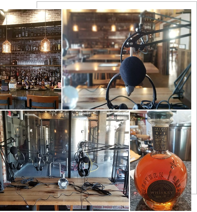 Group 95 Podcast recording setup in a rustic studio with hanging lights, microphones on tables, and a bottle of Western Reserve whiskey in the foreground.